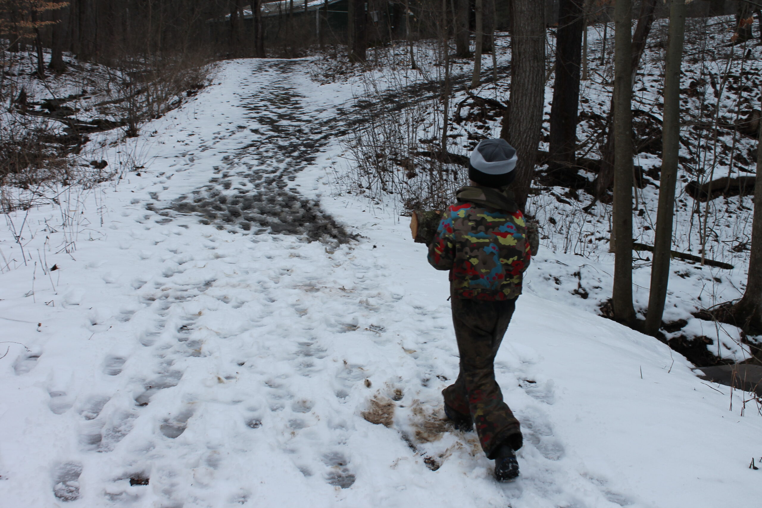 Someone walking through a path of snow. 