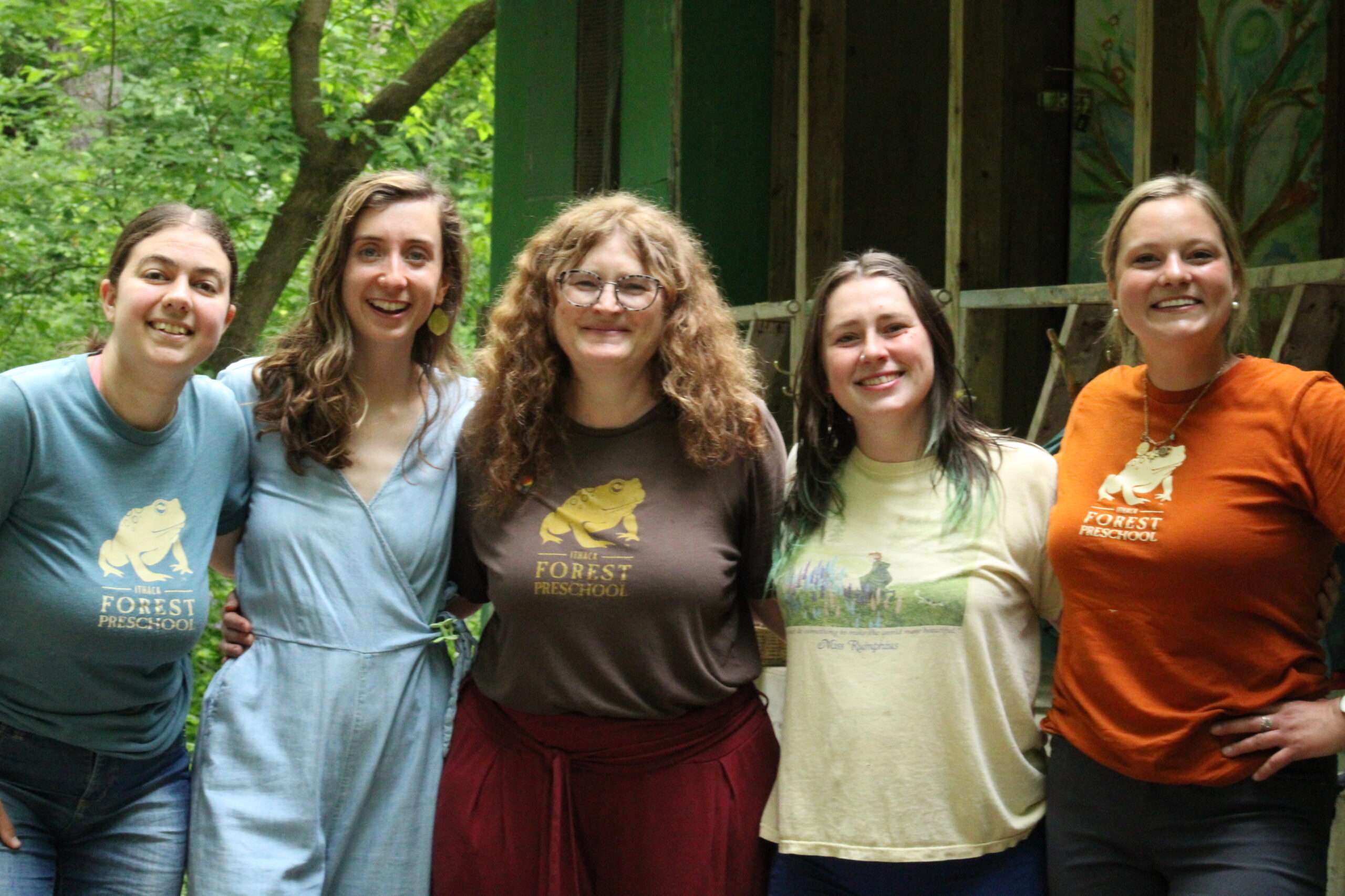 Group of young women all smiling for a group photo. 