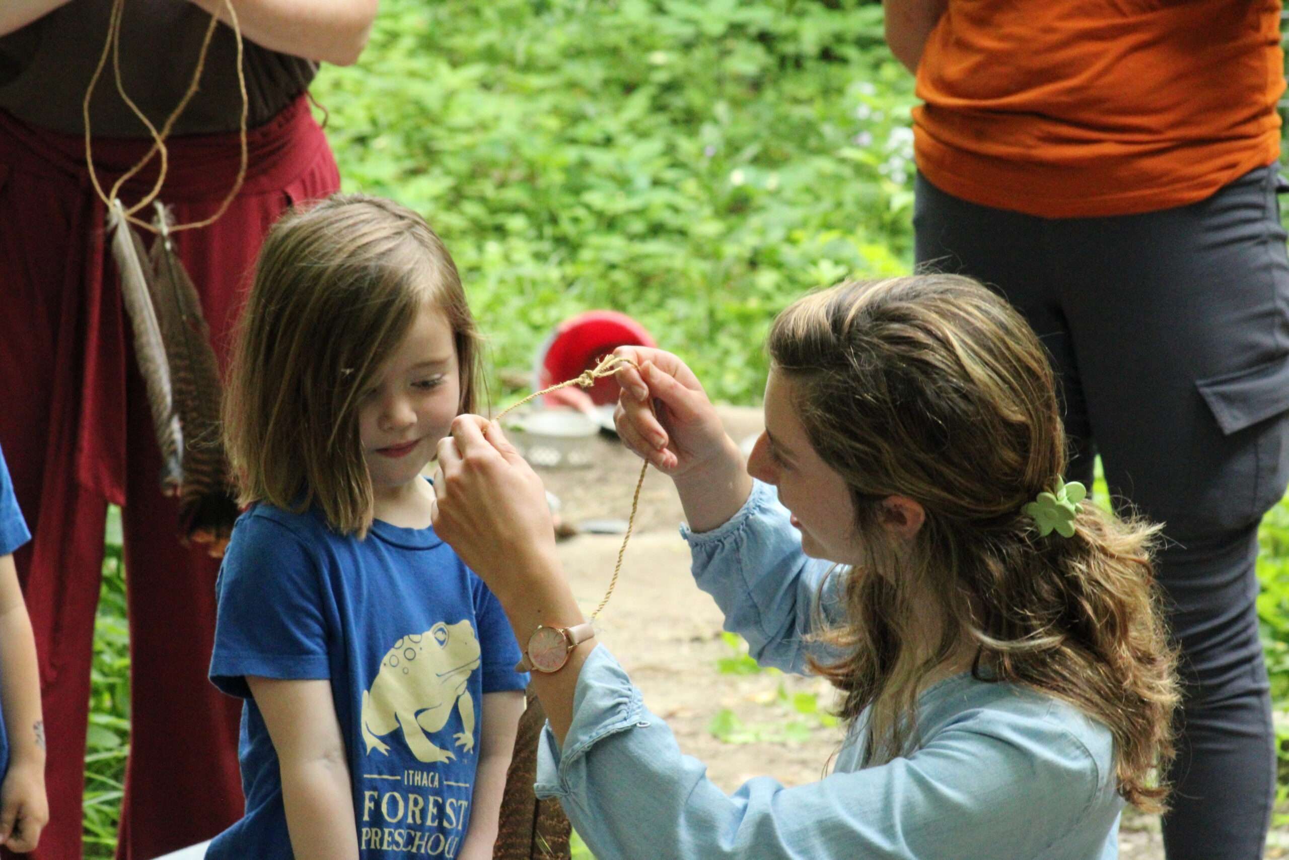 Camper helping a kid during summer camp.