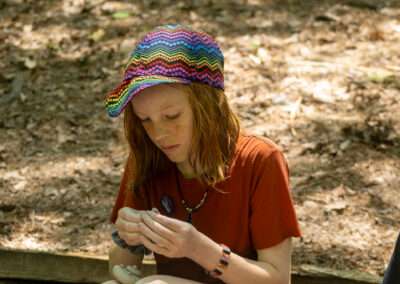 Camper making something out of clay.