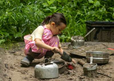 Younger camper playing in the sandbox.