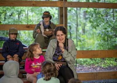 An instructor telling a story to a group of campers.
