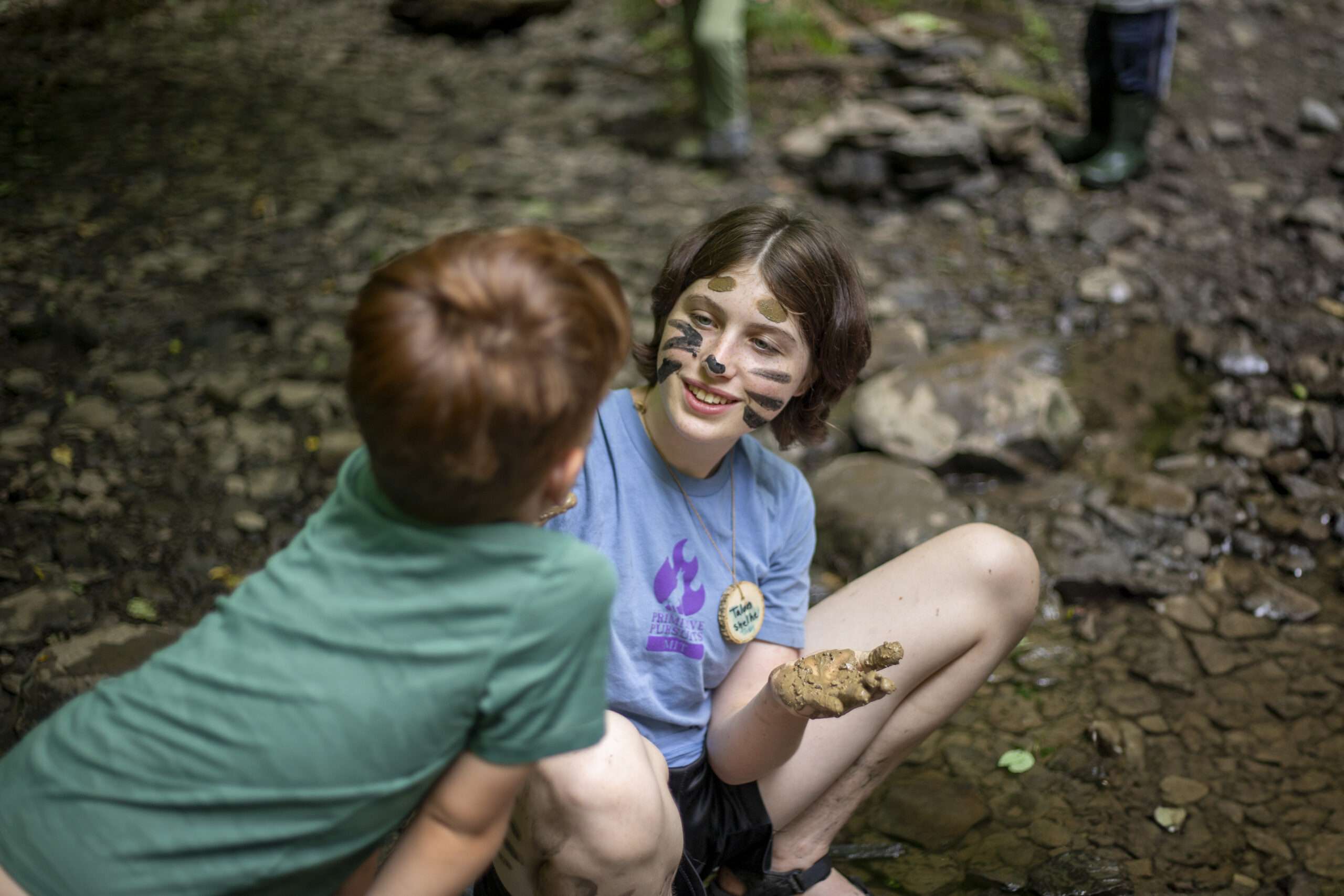 Young boy looking at a creek