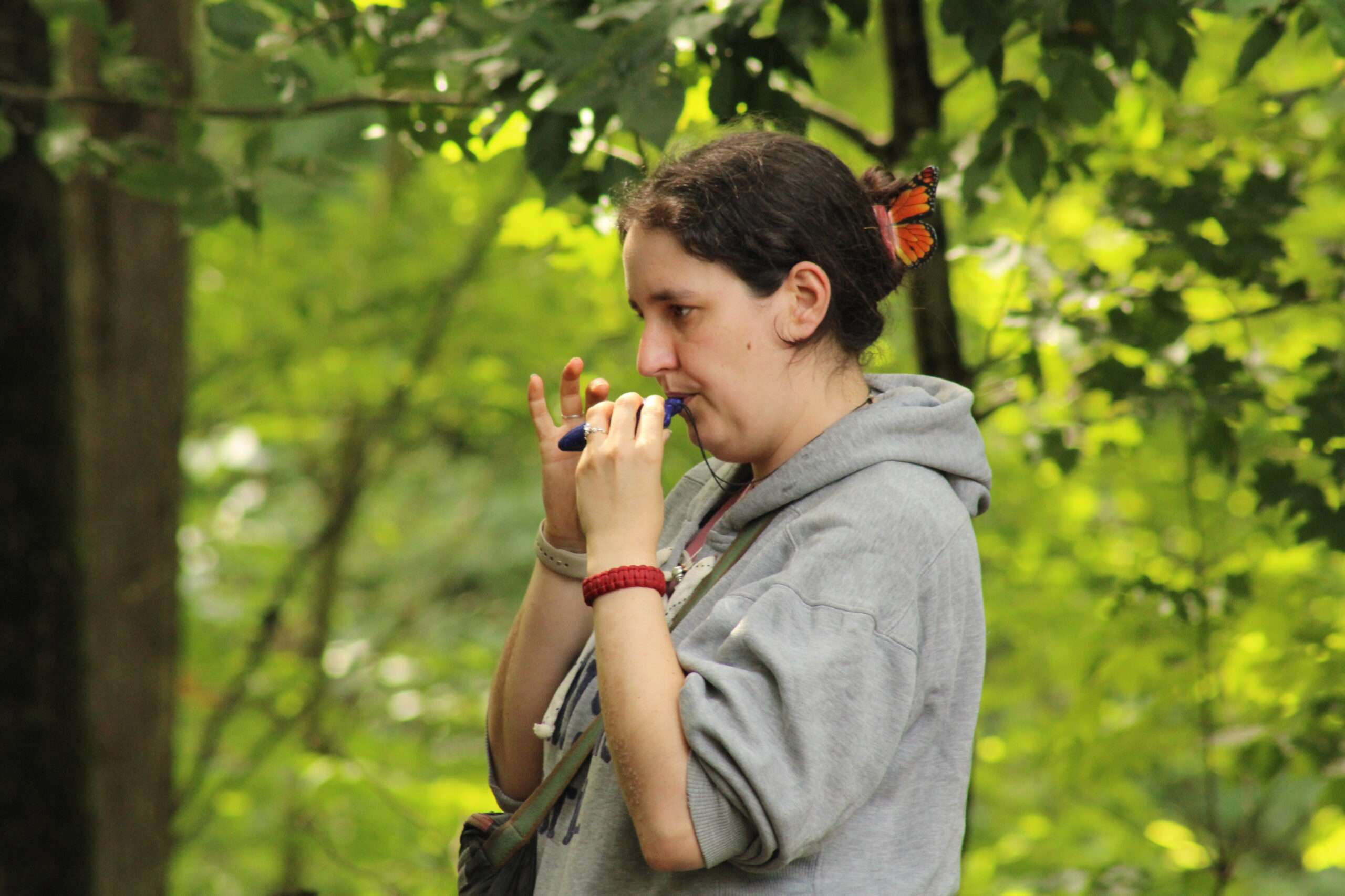 an instructor playing a musical instrument outside at camp